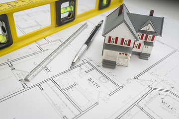 Image showing Model Home, Level, Pencil and Ruler Resting on House Plans