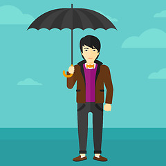 Image showing Businessman standing with umbrella.