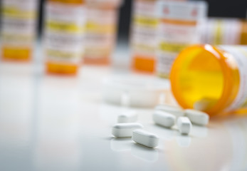 Image showing Medicine Bottles Behind Pills Spilling From Fallen Bottle