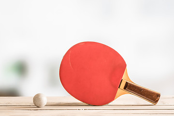 Image showing Table tennis bat with a ball