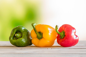 Image showing Pepper on a row on a wooden table