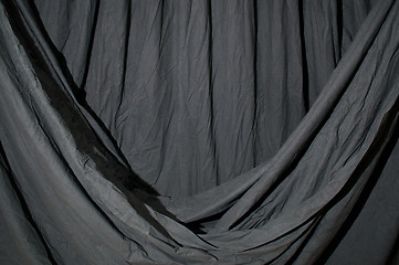 Image showing Draped black backdrop cloth lit by blue green gel