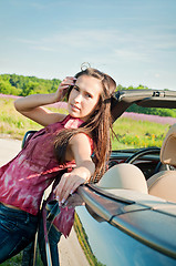 Image showing Lovely brunette female near car