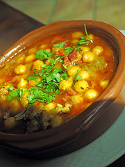 Image showing homemade bowl  garbanzo bean soup with fresh basil as served in 