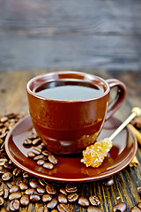 Image showing Coffee in brown cup with sugar and grain on board