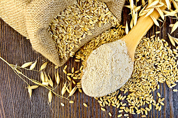 Image showing Flour oat in spoon with grain on board top