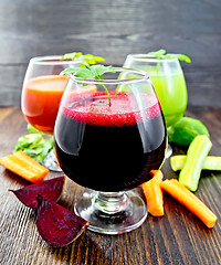 Image showing Juice beet and cucumber in wineglass on board