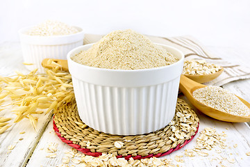 Image showing Flour oat in white bowl on board