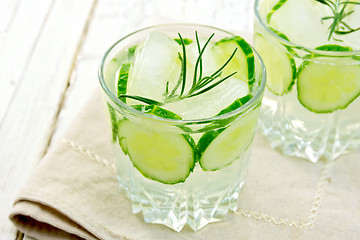Image showing Lemonade with cucumber and rosemary in two glassful on beige nap