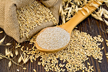 Image showing Bran flakes oat in spoon with grains on board