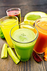 Image showing Juice cucumber and vegetable in four glassful on board