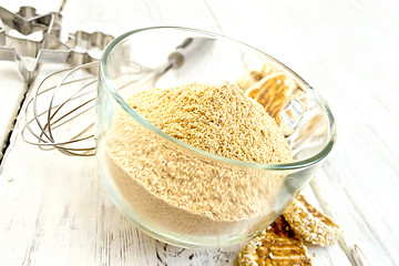 Image showing Flour sesame in cup with cookies on board