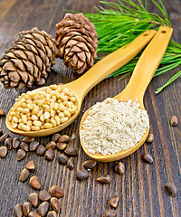 Image showing Flour and nuts cedar in spoon on board