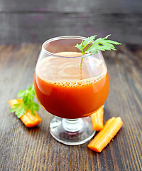 Image showing Juice carrot in wineglass on board