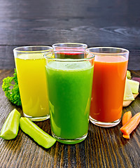 Image showing Juice cucumber and vegetable in glassful on dark board