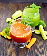 Image showing Juice carrot and cucumber in two wineglass on board