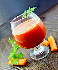 Image showing Juice carrot in wineglass on dark board