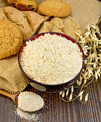 Image showing Flour oat in bowl with bread on board