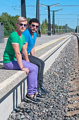 Image showing Two young men sitting on the platform