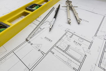 Image showing Construction Level, Pencil, Ruler and Compass Resting on House P