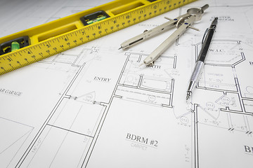 Image showing Construction Level, Pencil, Ruler and Compass Resting on House P