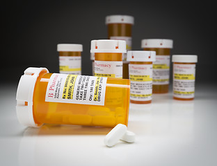 Image showing Medicine Bottles and Pills on Reflective Surface With Grey Backg