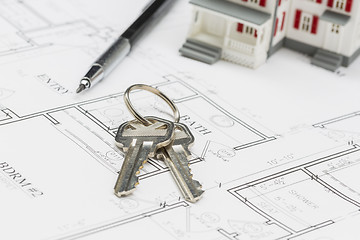 Image showing Model Home, Engineer Pencil and Keys Resting on House Plans