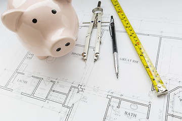 Image showing Bank, Compass, Pencil and Measuring Tape Resting on House Plans