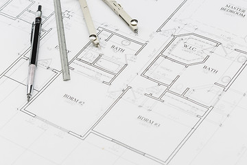 Image showing Engineer Pencil, Ruler and Compass Resting on House Plans