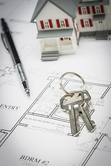 Image showing Model Home, Pencil and Keys Resting On House Plans