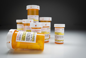 Image showing Medicine Bottles on Reflective Surface and Grey Background