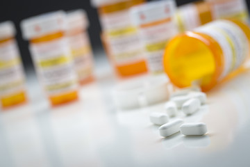 Image showing Medicine Bottles Behind Pills Spilling From Fallen Bottle