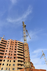 Image showing Crane and building construction site against blue sky