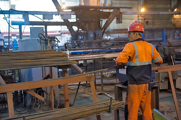 Image showing Worker in reinforcing shop