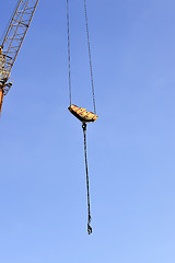 Image showing Crane and building construction site against blue sky