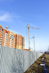 Image showing Crane and building construction site against blue sky