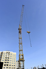 Image showing Crane and building construction site against blue sky