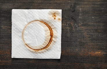 Image showing used paper napkin on dark wooden table