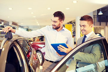 Image showing happy man with car dealer in auto show or salon