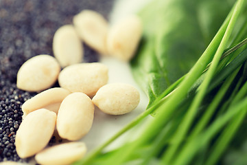 Image showing close up of peeled peanuts, greens and seeds