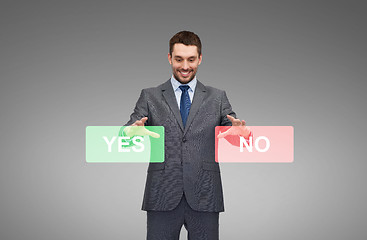 Image showing smiling businessman with yes and no buttons