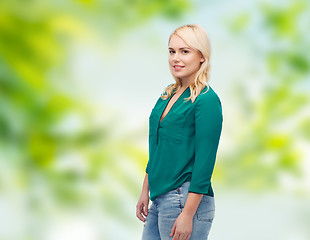 Image showing smiling young woman in shirt and jeans