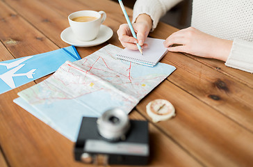 Image showing close up of traveler hands with notepad and pencil