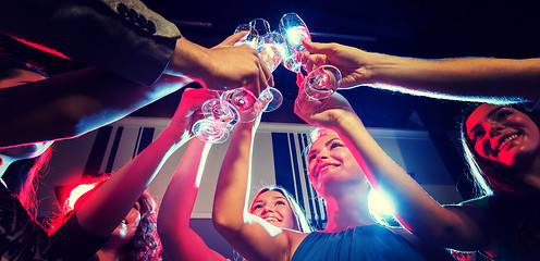 Image showing smiling friends with glasses of champagne in club