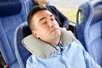 Image showing man sleeping in travel bus with cervical pillow