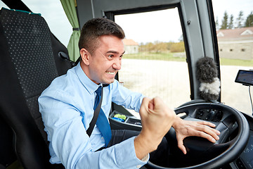 Image showing angry driver showing fist and driving bus