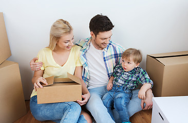 Image showing happy family with boxes moving to new home