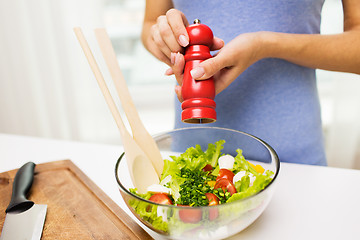 Image showing close up of woman cooking vegetable salad at home