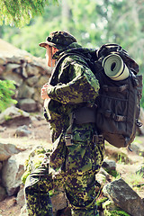 Image showing young soldier with backpack in forest