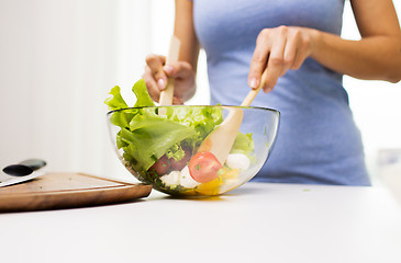 Image showing close up of woman cooking vegetable salad at home